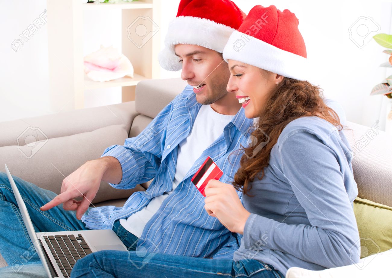 16052411-Couple-with-credit-card-buying-online-Christmas-Shopping--Stock-Photo.jpg