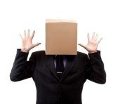 9024262-businessman-with-a-brown-box-on-his-head-in-white.jpg