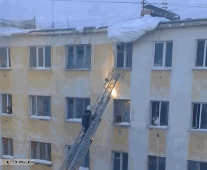 1379435923_rooftop_snow_falls_on_fireman.gif