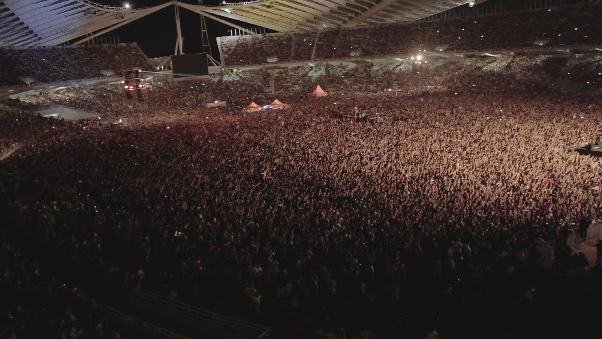 huge-crowd-of-people-at-concert-full-stadium-arena-overviewaerial-view-of-one-of-the-biggest-crowds-in-a-live-outdoors-rock-concert-in-athens-greece-at-the-olympics-stadium_vyrwvyjp__F0000.png